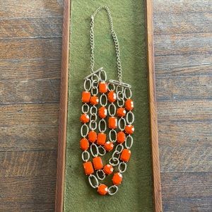 Bright orange and gold tone necklace